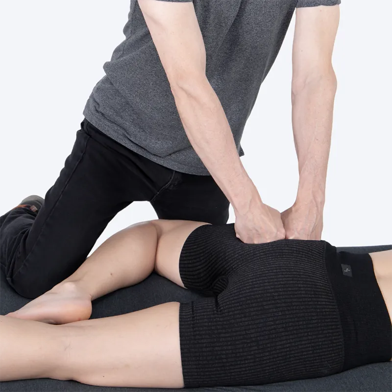 WIN_25_MyoskeletalAlignment4 A massage therapist works on a client's gluteal muscles.