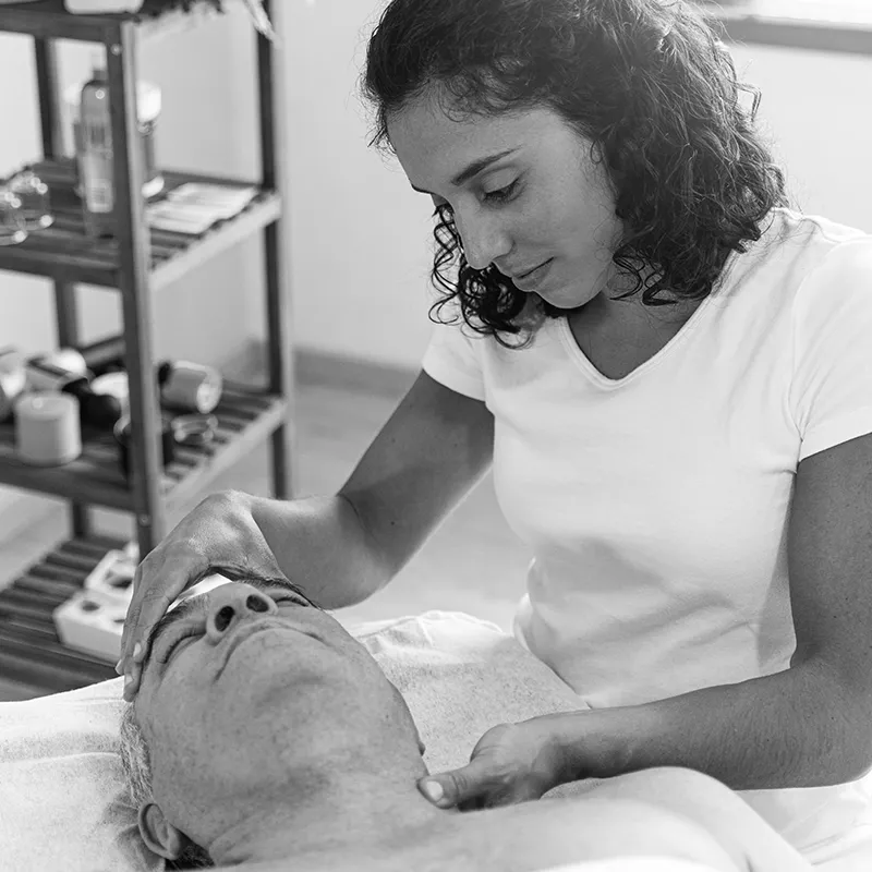 WIN_25_ClinicalExplorations_Secondary1_Stocksy_3206196_800 A female massage therapist touches a client's forehead and neck.